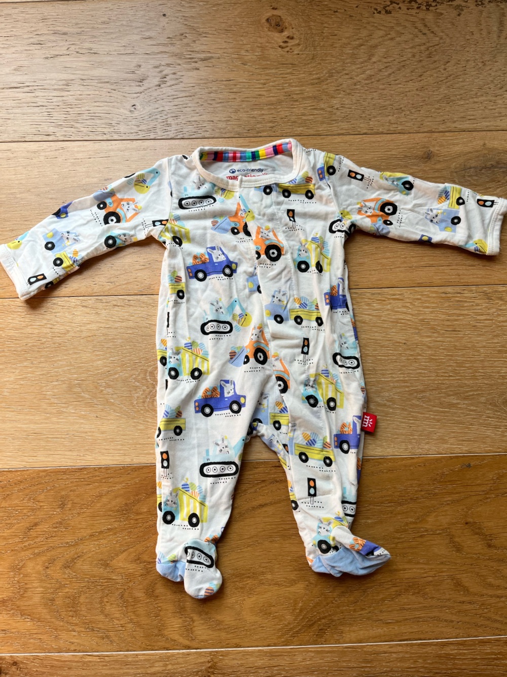 Magnetic Me Unisex White Footie with Blue, Yellow, Orange Truck Print